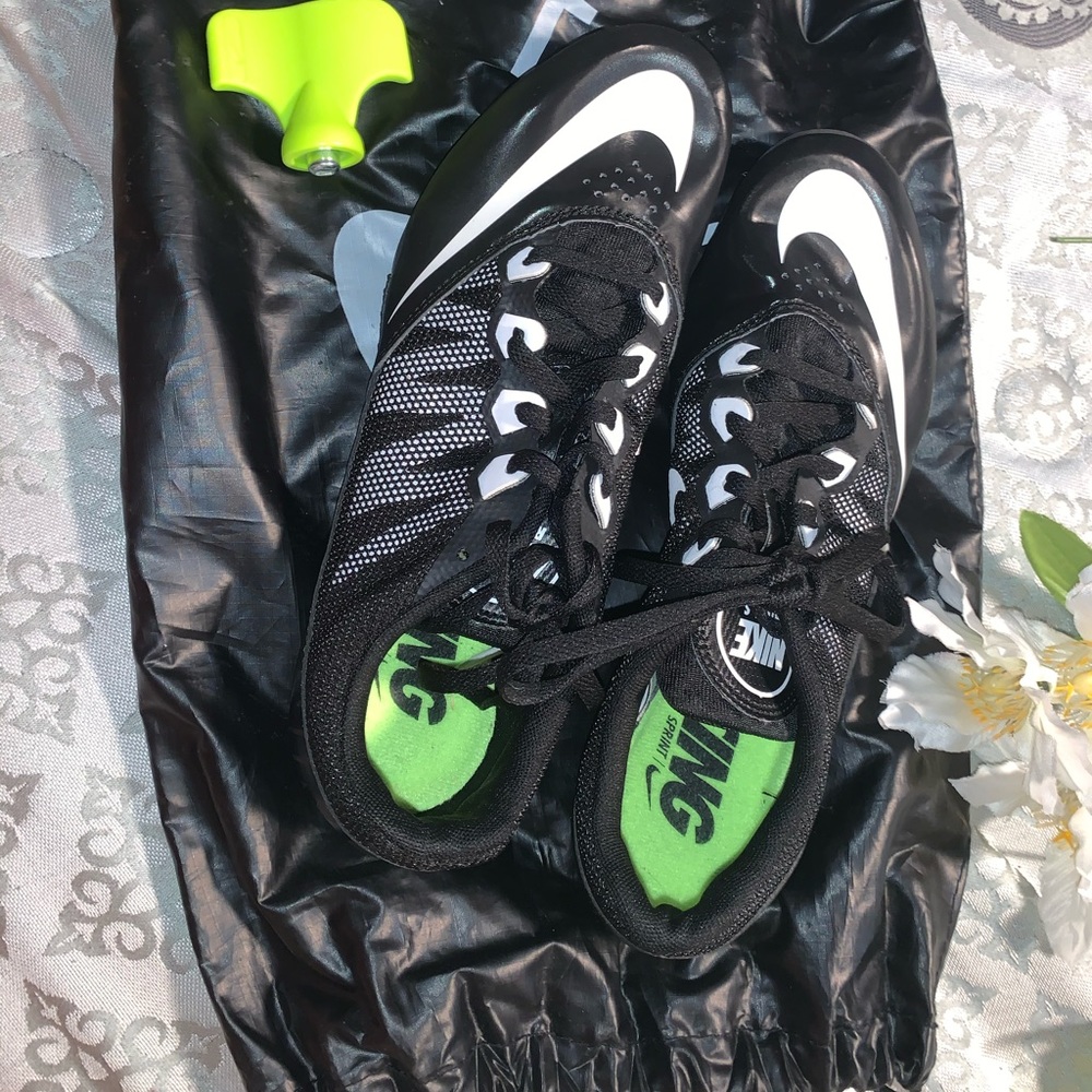 Black and white track spikes / shoes